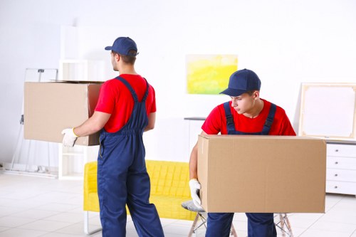 Movers protecting furniture during a careful house removal