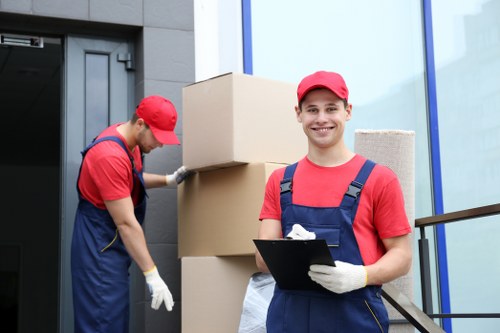 Movers carrying furniture from a Harringay property