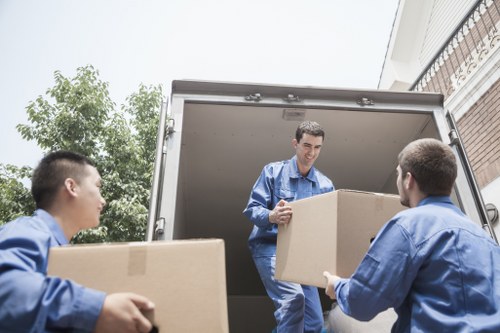 Professional movers loading commercial items for transport in North London