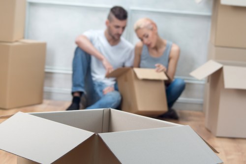 Flat removal service in Harringay with movers carrying items down stairs