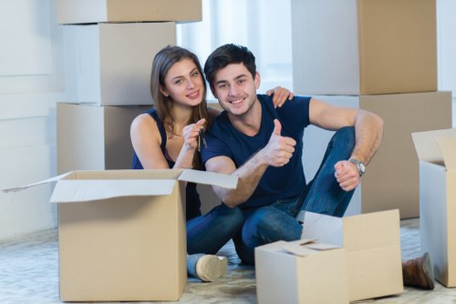 Mover wearing PPE while carrying household items